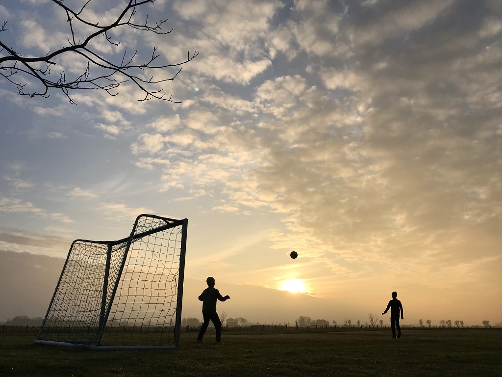 Playing football on a sunny winterday